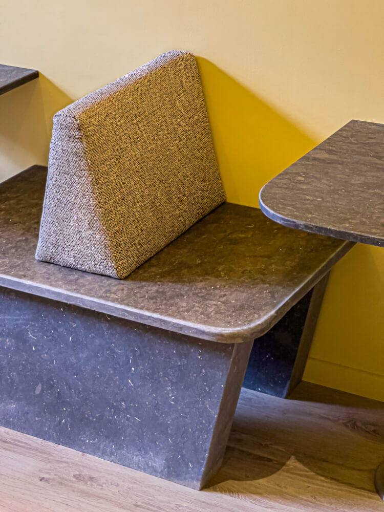 Stone bench in a low-budget restaurant's seating area.
