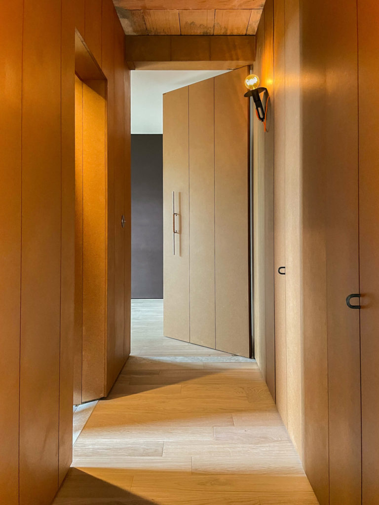 Sleek invisible door in the apartment corridor.