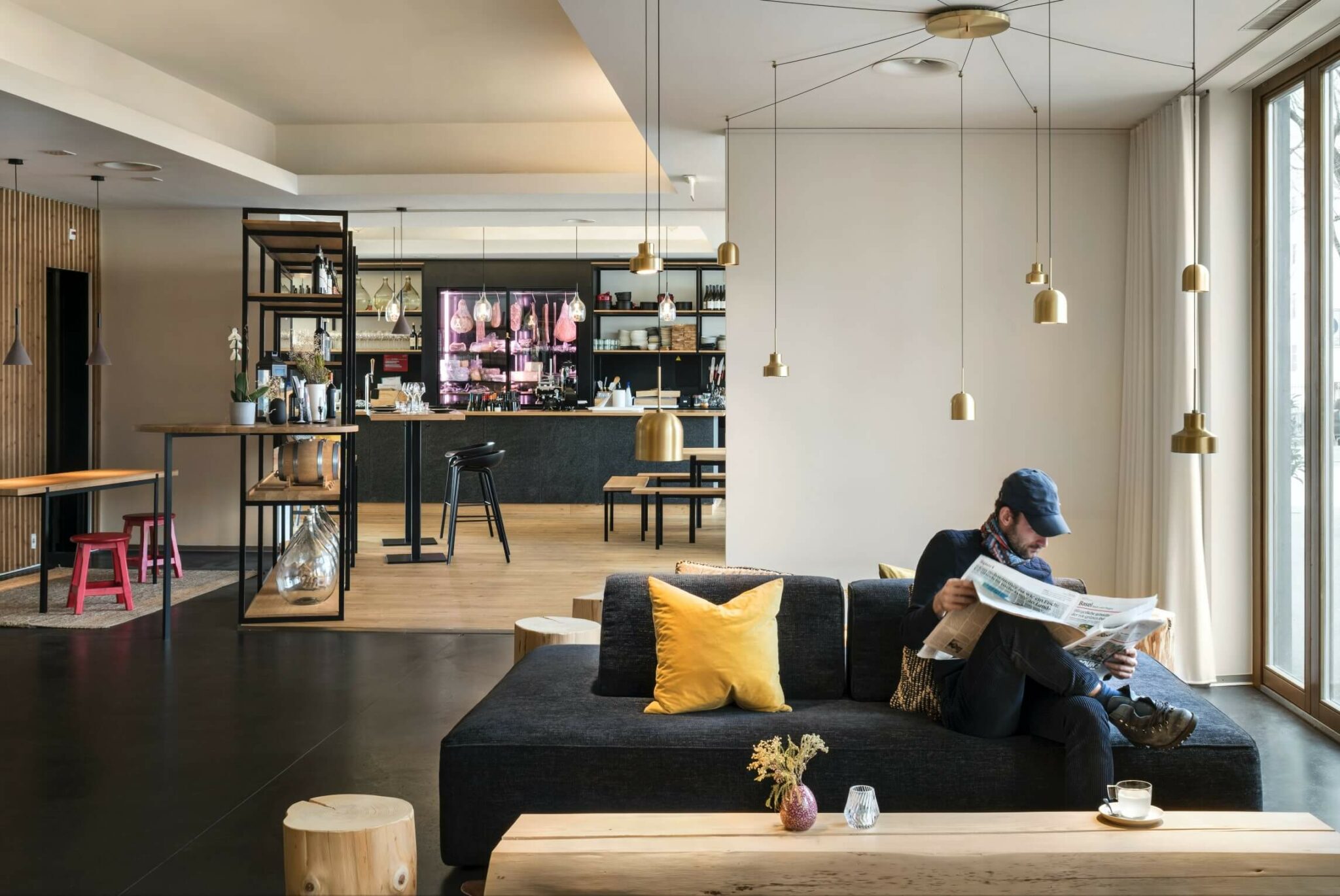 Spacious lounge layout with low sofas and poufs.