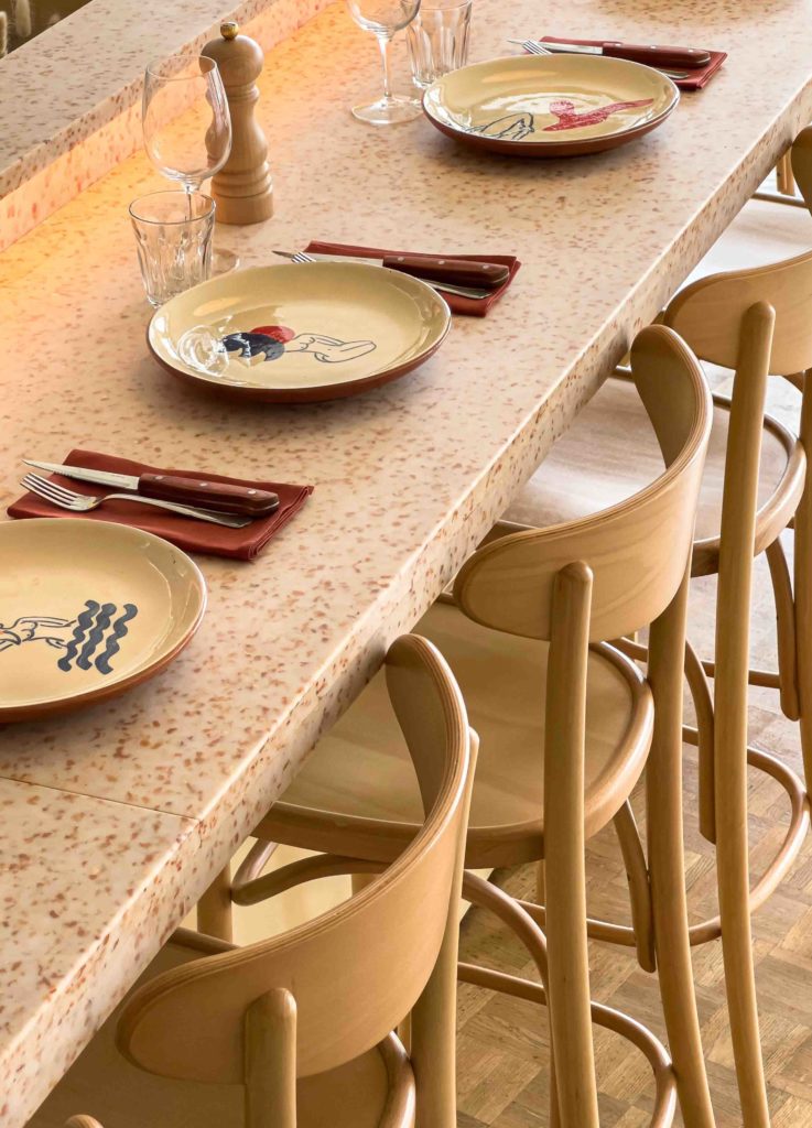 Unique counter chairs in the pizzeria restaurant design by HOXAR STUDIO.