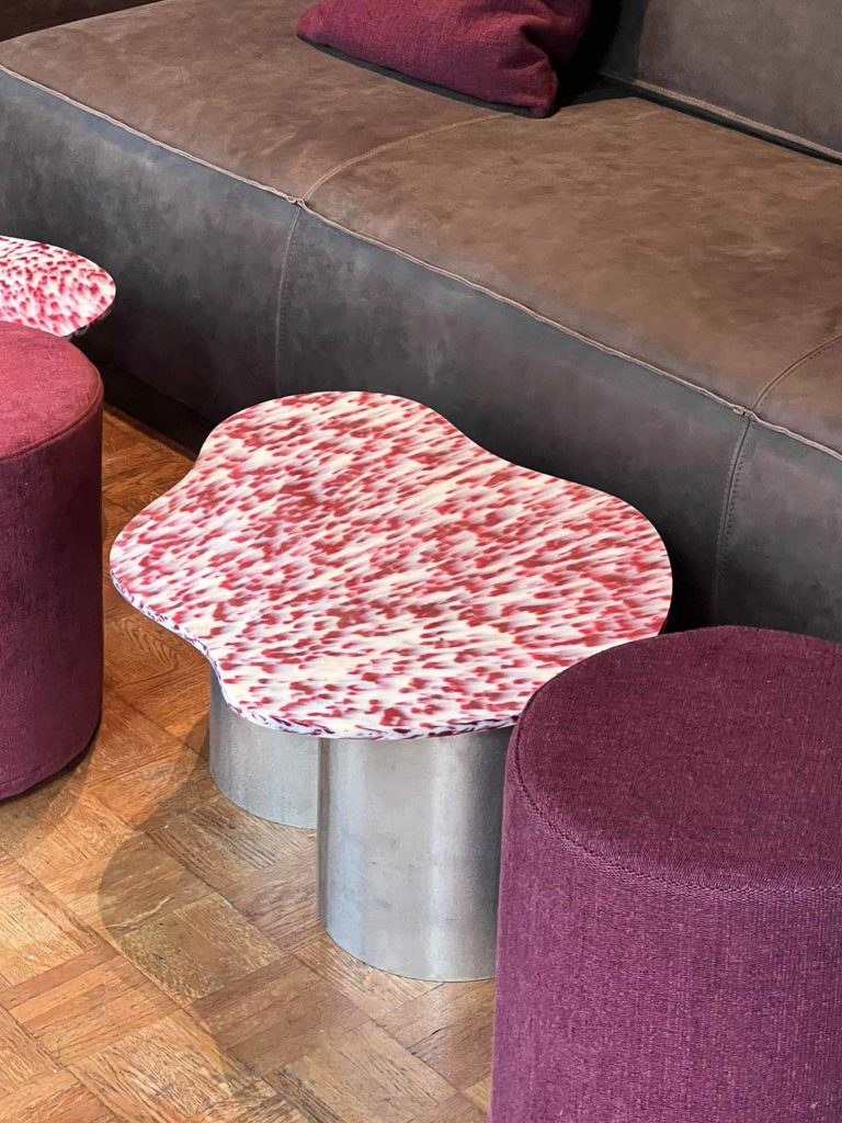 Unique drop table in the lounge area of pizzeria restaurant design.