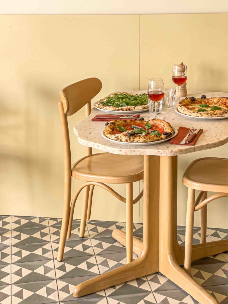 Distinctive table shape in HOXAR STUDIO's pizzeria restaurant design.